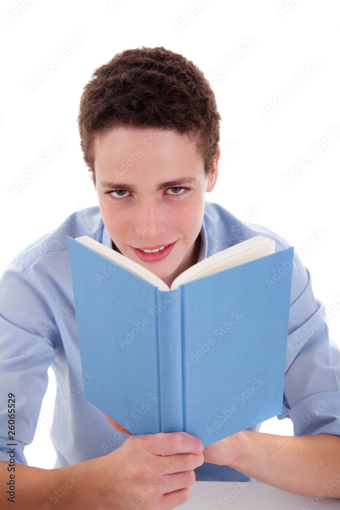 cute boy reading a book on his desk cute boy reading a book on his desk