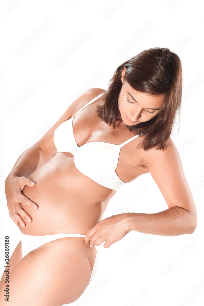 Obraz premium Pregnant woman examining her hips