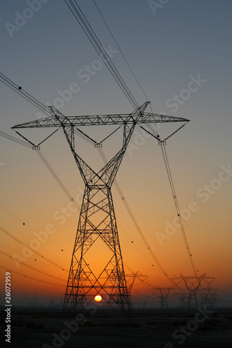 Electricity pylons at sunset © skylightpictures