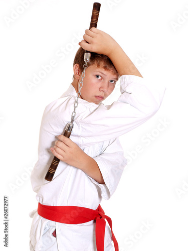Teenage in kimono making exercise with nunchuck