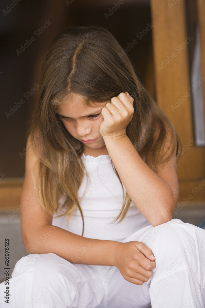 Grumpy Hispanic girl with head in hands Grumpy Hispanic girl with head in hands