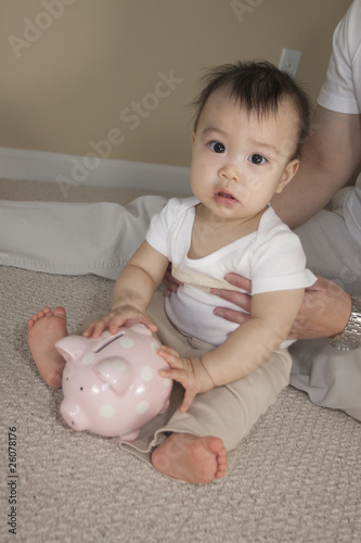 Chinese father and baby with piggy bank photo