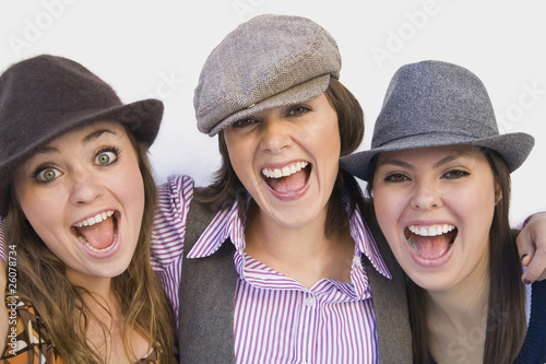 Hispanic friends in old-fashioned hats laughing photo