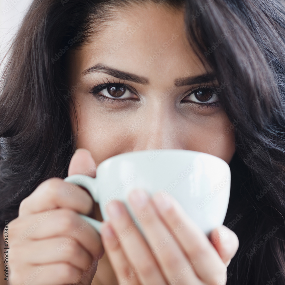 Close up of Middle Eastern woman drinking coffee Close up of Middle Eastern woman drinking coffee