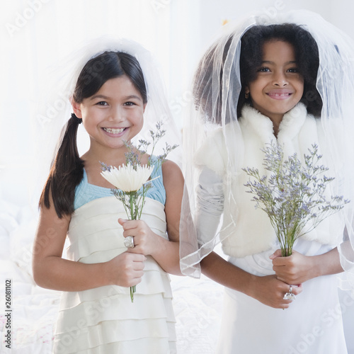 Girls dressing up in wedding dress