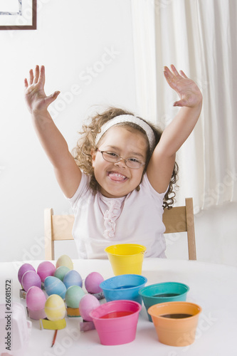 Hispanic girl decorating Easter eggs photo