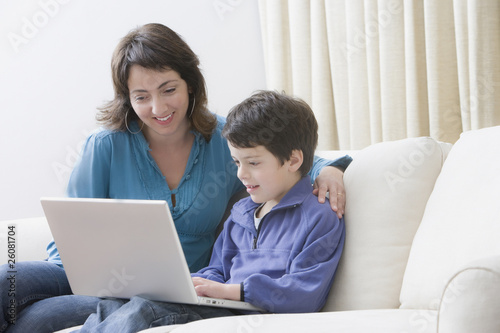 Hispanic mother and son using laptop photo