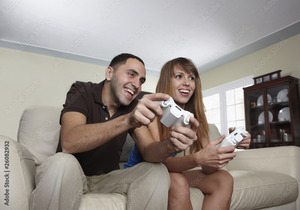 Hispanic husband and wife playing video game Hispanic husband and wife playing video game