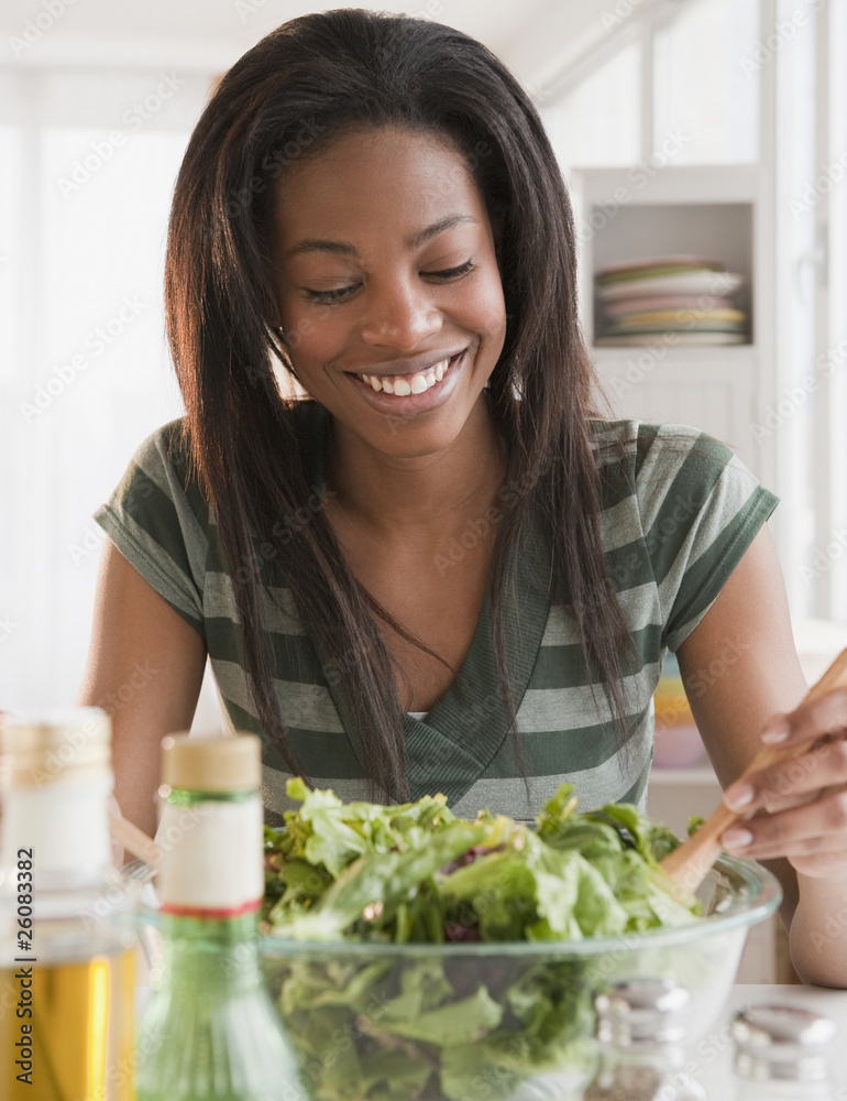 Mixed race woman tossing salad Mixed race woman tossing salad