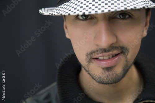 Hispanic man in hat and leather coat