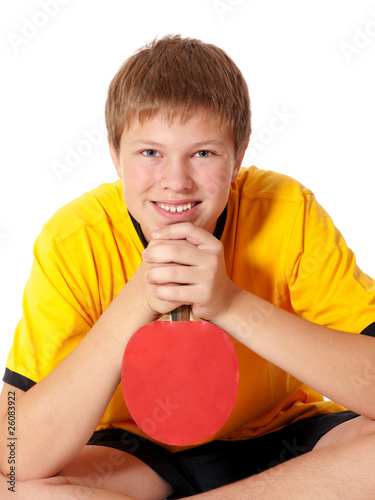 Teenage in yellow T-shirt with ping pong rocket
