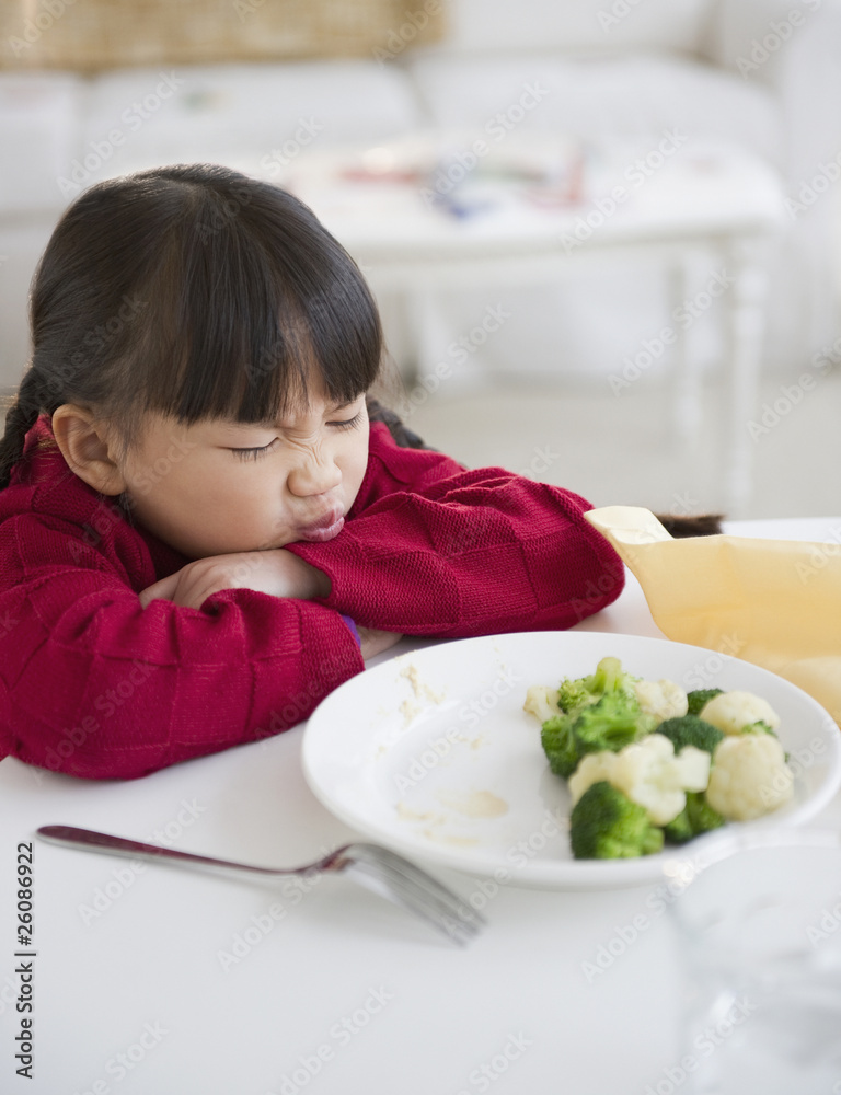 Chinese girl refusing to eat vegetables Chinese girl refusing to eat vegetables