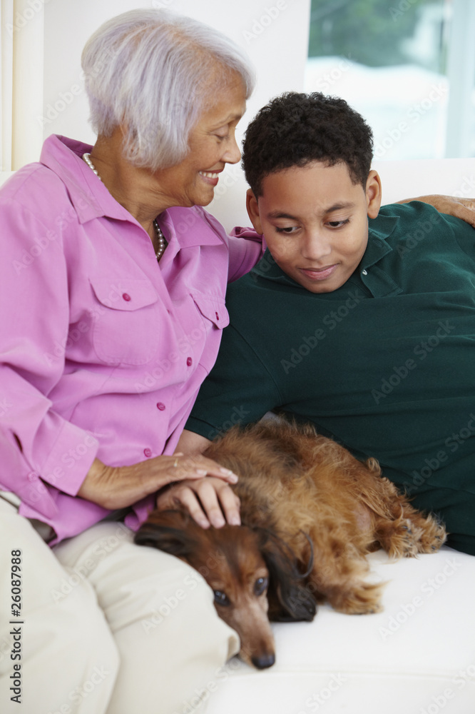African American grandmother and grandson petting dog African American grandmother and grandson petting dog