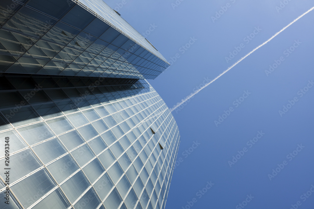 Obraz premium office building and contrail in the sky