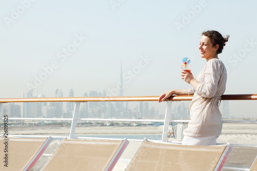 woman with cocktail standing on cruise liner deck photo