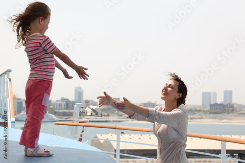 mother and daughter stretching hands to each other