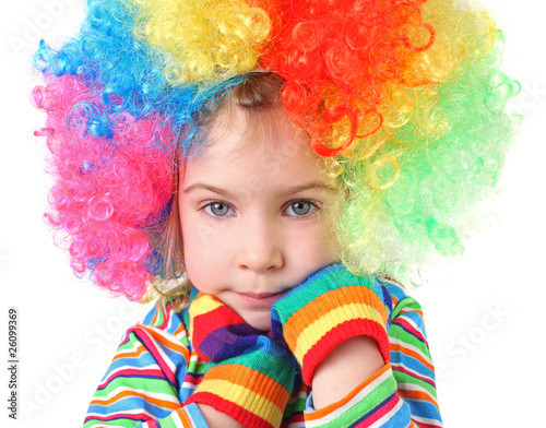 girl in clown wig and multicolored gloves looking