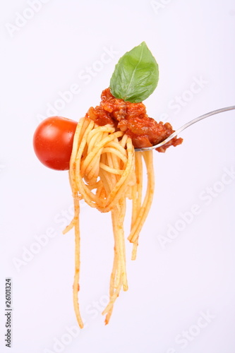 Spaghetti bolognese hanging on a fork with a cherry tomato