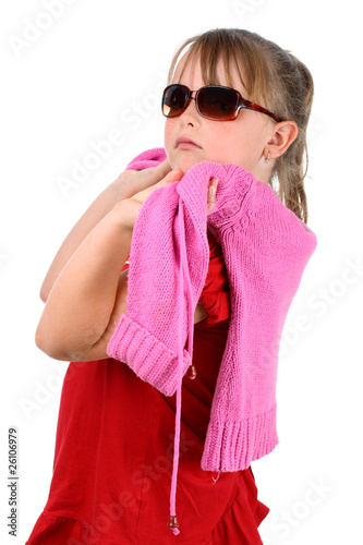 Proud small girl with pink sweater looking at camera isolated