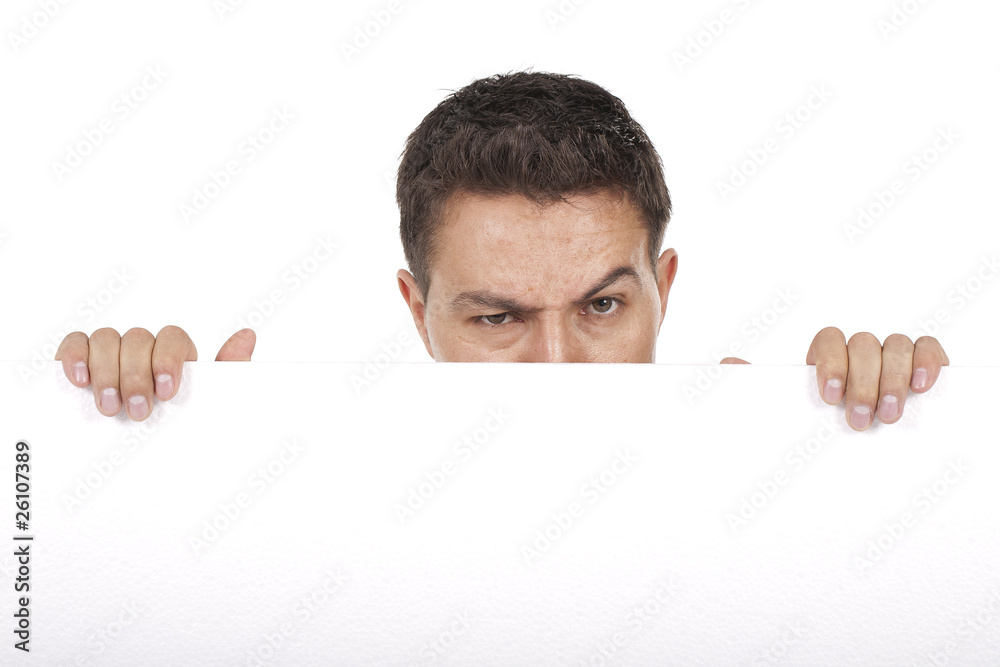 man peeking behind empty white billboard