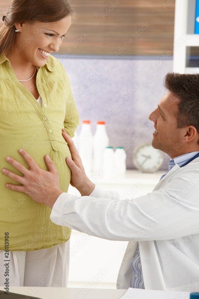 Doctor touching pregnant belly Doctor touching pregnant belly
