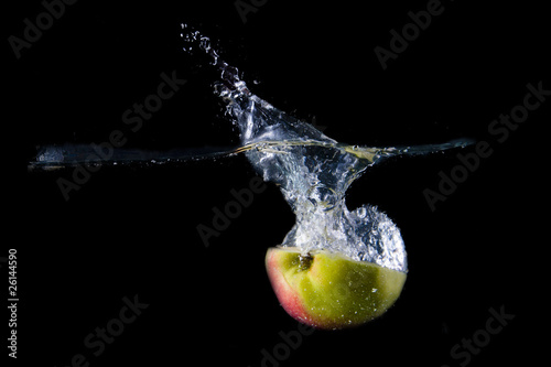 Apple splashing on black background