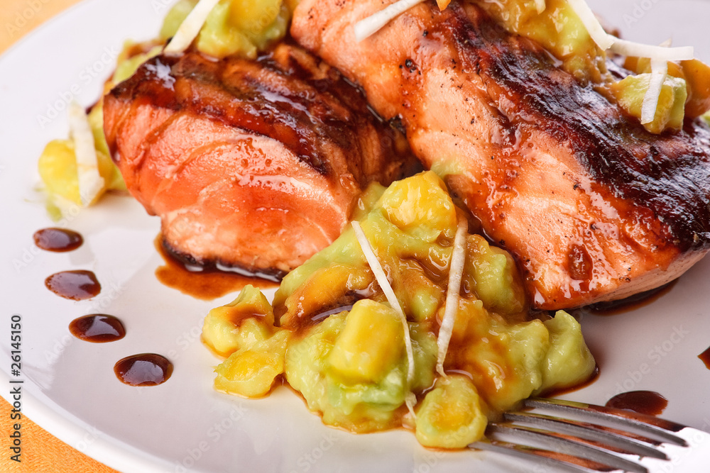 Salmon with mashed avocado and mango (close-up) Salmon with mashed avocado and mango (close-up)