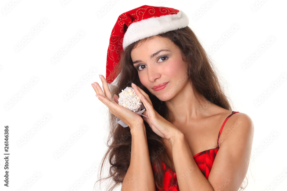 Beautiful Christmas woman in red santa hat holding Xmas decorati Beautiful Christmas woman in red santa hat holding Xmas decorati
