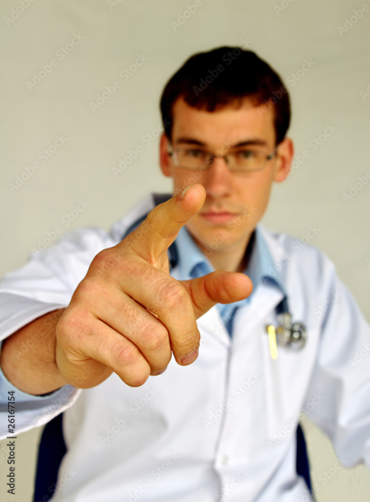 Portrait of friendly therapist pointing at you and looking at ca Portrait of friendly therapist pointing at you and looking at ca