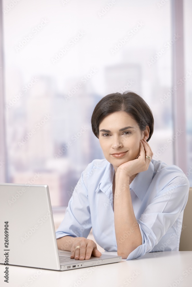 Portrait of female office worker with computer Portrait of female office worker with computer