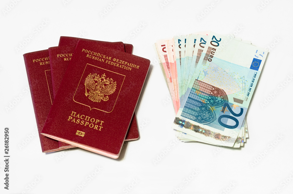 Two red passports and euro cash small banknotes on white Two red passports and euro cash small banknotes on white
