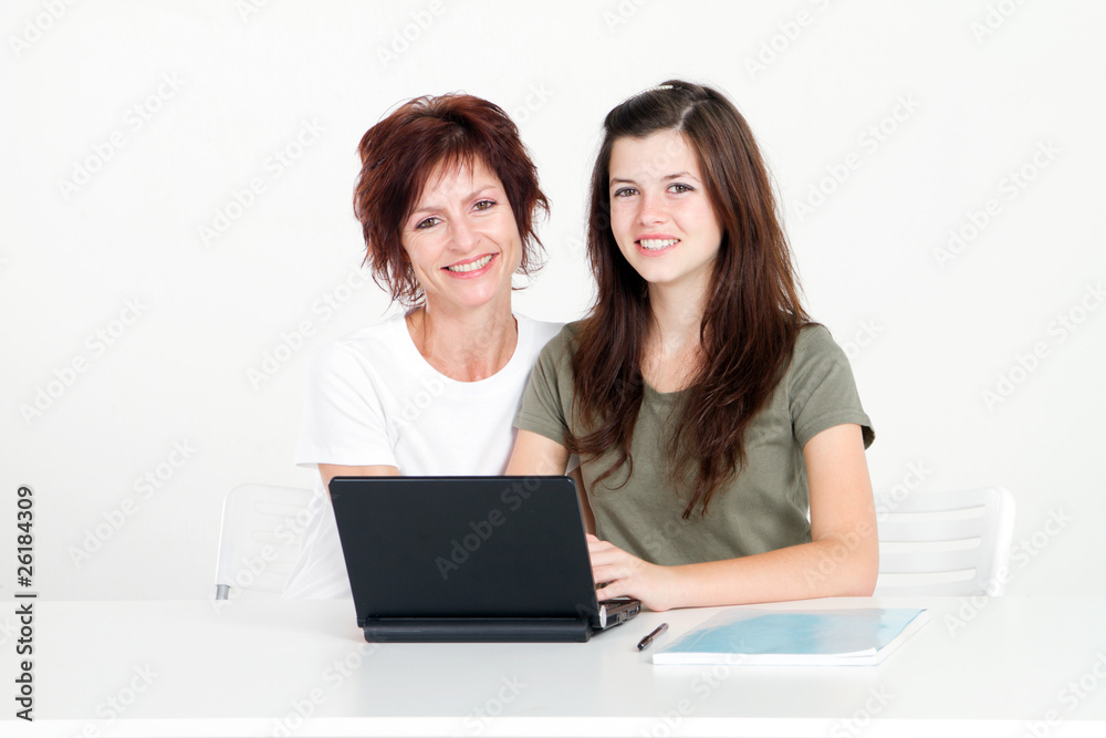 mother and daughter using laptop