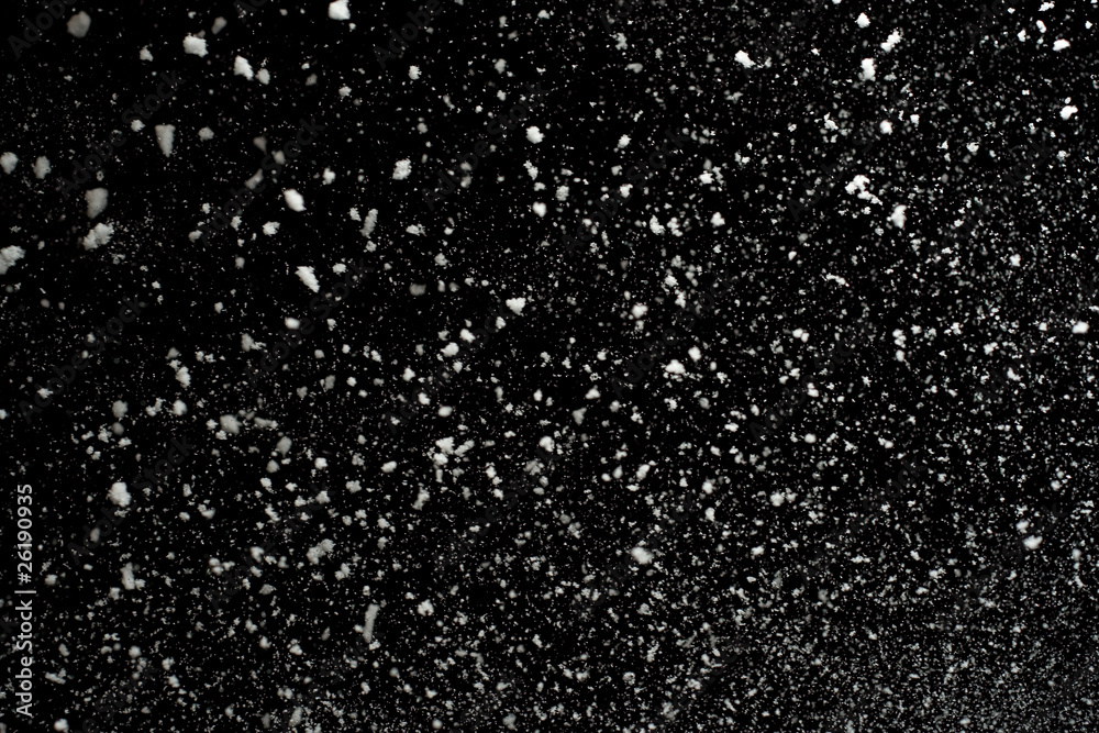 Flying snowflakes on black background