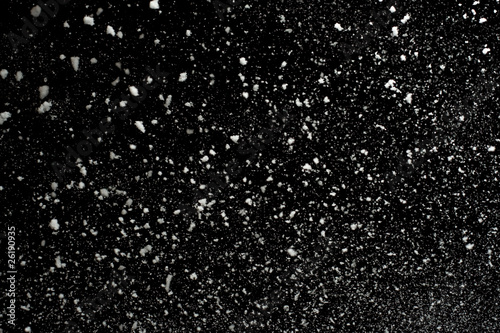 Flying snowflakes on black background