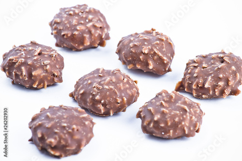 Delicious chocolate pralines over white background.