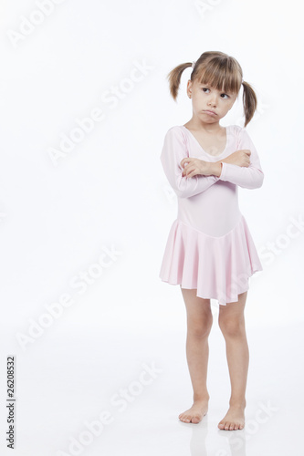Upset little girl in pink outfit