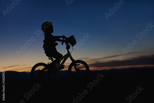 Girl on a Bike at Sunset