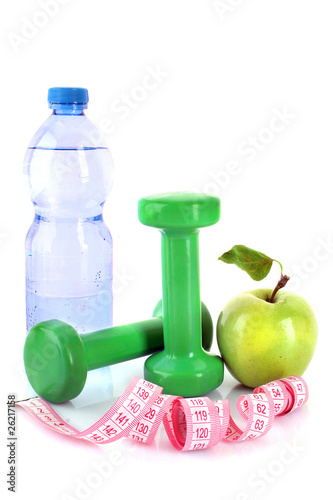 Dumbbells, green apple, measuring tape and a bottle of water iso