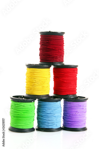 Coloured bobbins of thread isolated on white