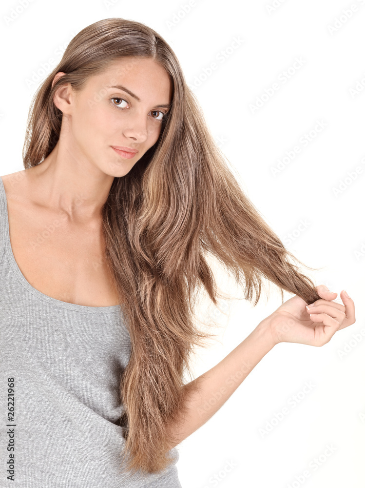 Young brunette beautiful lady playing with long hairs on white Young brunette beautiful lady playing with long hairs on white