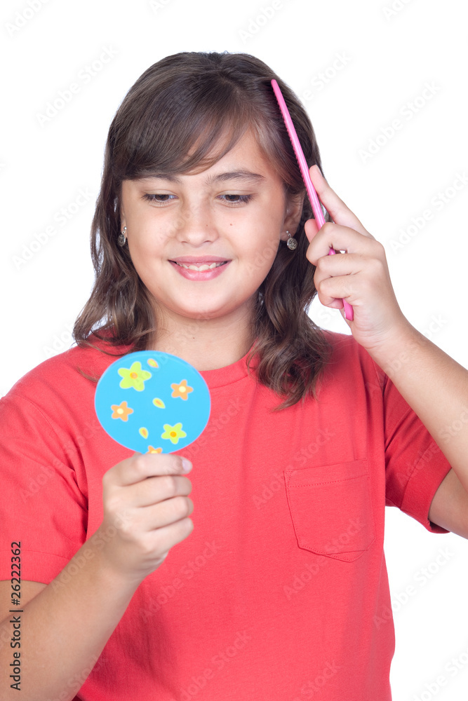 Preteen girl combing with a comb in front of a mirror Preteen girl combing with a comb in front of a mirror