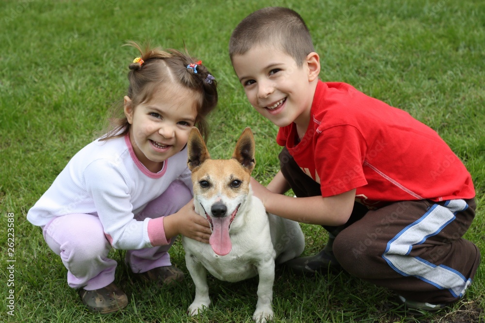Obraz premium Two cute happy kids with dog
