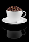 Cup of coffre with coffee beans on reflected black background