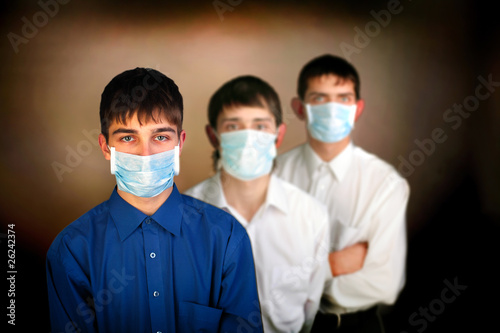 three teenagers in the mask on the dark background