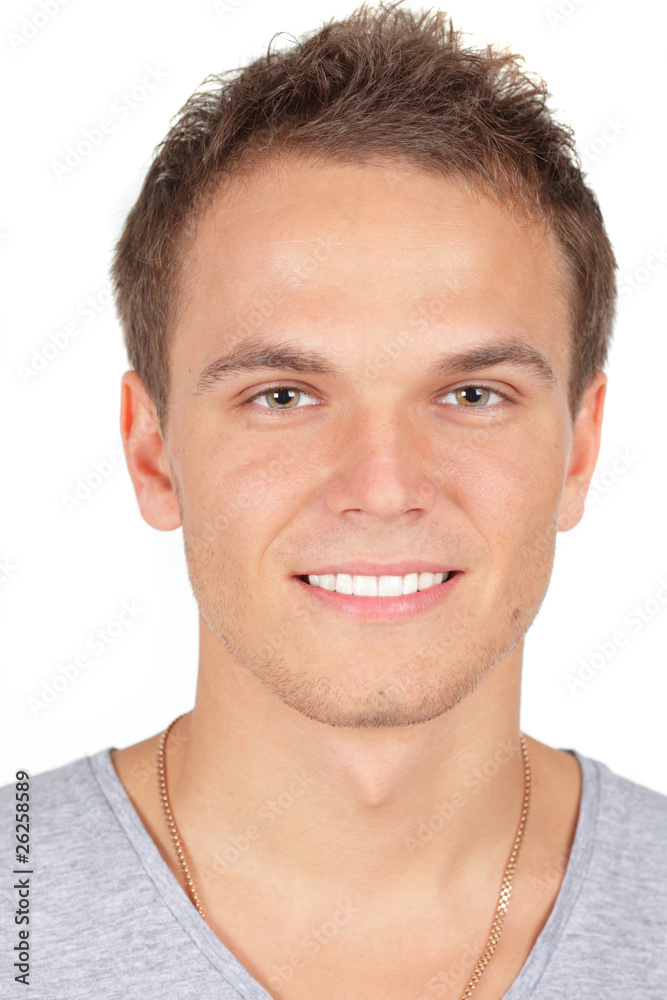 Obraz premium Handsome young man smiling. Isolated on white.