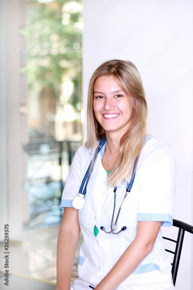A pretty young woman nurse inside hospital building A pretty young woman nurse inside hospital building