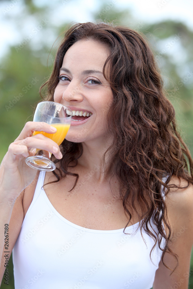 Closeup of beautiful woman drinking orange juice Closeup of beautiful woman drinking orange juice
