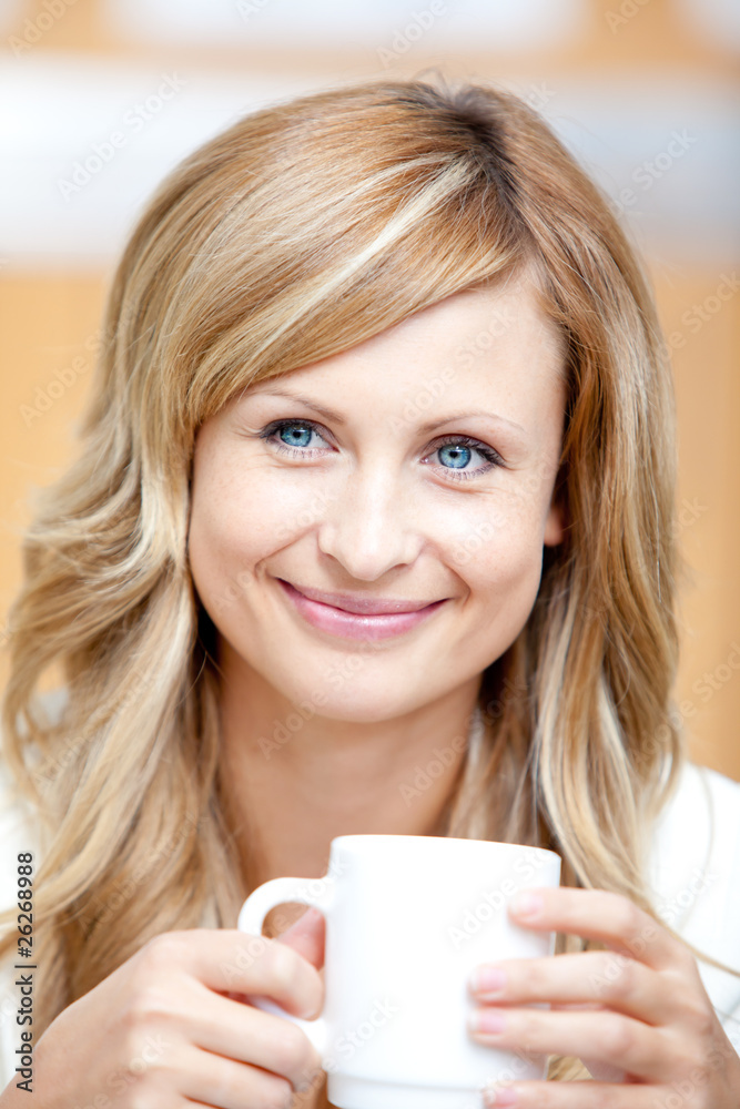 Smiling businesswoman holding a cup of coffee Smiling businesswoman holding a cup of coffee