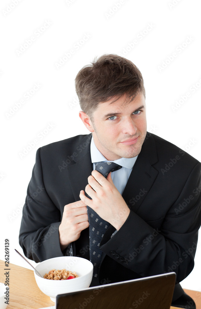 Elegant businessman having breakfast and touching his tie in fro Elegant businessman having breakfast and touching his tie in fro