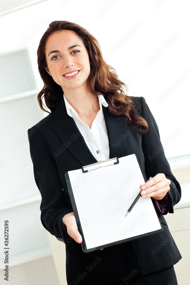 Portrait of a charismatic hispanic businesswoman holding a clipb Portrait of a charismatic hispanic businesswoman holding a clipb